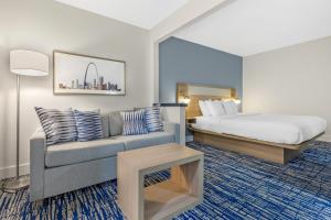 a hotel room with a bed and a couch at Best Western St. Louis Fairview Heights in Fairview Heights