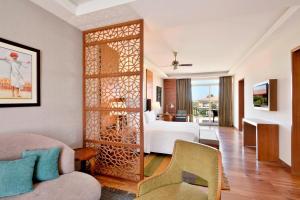 a hotel room with a bed and a living room at The Westin Pushkar Resort & Spa in Pushkar