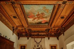 a ceiling in a room with a painting on it at Villa Wirnica Lake Como in Garlate