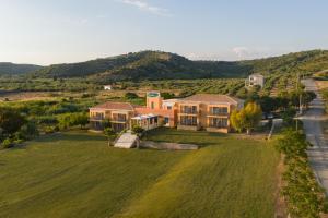 an aerial view of a large house with a green field at Finiki Plaza in Methoni