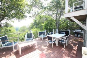 a deck with blue chairs and a table and chairs at The Viewpoint in Provincetown
