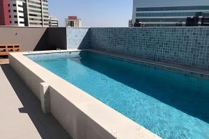 a swimming pool on the roof of a building at Studio 810 | Completo e Novo | SP Expo e Congonhas in São Paulo