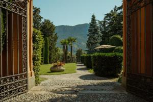 an entrance to a garden with a pathway at Villa Wirnica Lake Como in Garlate +37 photos