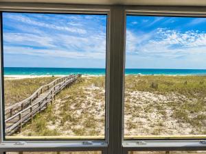 a view of the beach from a window at Perdido Key Beachfront 4BR Sleeps 12 Steps to the Beach Sweeping Gulf View in Pensacola