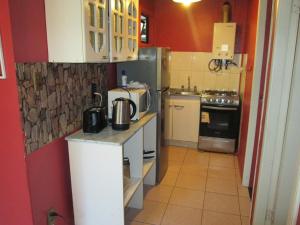 a small kitchen with a refrigerator and a microwave at Cabañas Buin in Puerto Montt