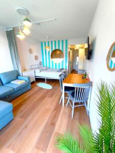 a living room with a blue couch and a table at MOOKI Sky by Lake in Villach +40 photos
