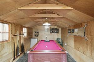 a pool table in the middle of a room at Dunella Traditional Cottage in Callander