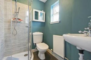 a bathroom with a toilet and a sink at Dunella Traditional Cottage in Callander +16 photos