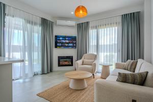 a living room with a couch and a fireplace at Kaura Villas in Milas