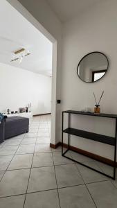 a living room with a mirror and a tiled floor at Terra intelvi in San Fedele Intelvi