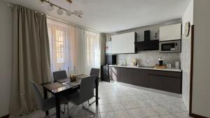 a kitchen with a table and a dining room at Terra intelvi in San Fedele Intelvi