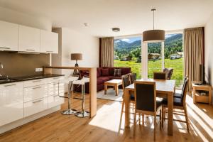 a kitchen and living room with a couch and a table at Silva Peak Residences Galtür in Galtür