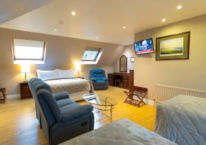 a hotel room with a bed and a tv at The Tides Ballybunion in Ballybunion
