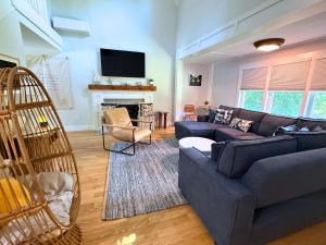 a living room with a couch and a fireplace at Tidepools Retreat Poolside Family Fun in York