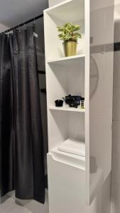 a white shelf with a plant in a bathroom at Terra intelvi in San Fedele Intelvi +32 photos