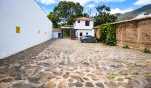 a car parked in a parking lot next to a building at Hotel Beth Sarim in Villa de Leyva