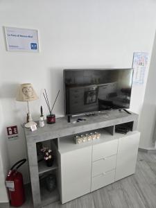 a flat screen tv on a white entertainment center at La Casa di Nonna Mari in Moneglia