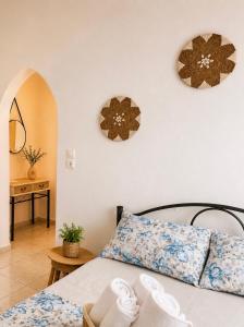 a bedroom with a bed and two mirrors on the wall at Puerto Porto Koufo in Porto Koufo