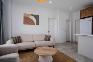 a living room with a couch and a table at Kaura Villas in Milas