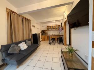 a living room with a couch and a kitchen at Suites Xico Oaxaca in Oaxaca City +16 photos