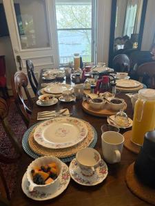 a table with plates and bowls of food on it at Hillside Landing B&B in Digby