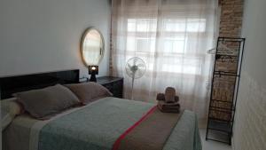 a bedroom with a bed and a mirror on the wall at A parada da Ribeira in Ourense