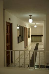 an empty room with a balcony and a hallway at Hotel Los Proceres in La Aurora