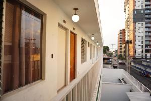 a balcony with windows and a view of a street at Hotel Los Proceres in La Aurora