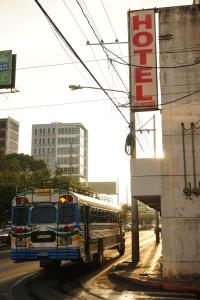 a school bus driving down a city street at Hotel Los Proceres in La Aurora +28 photos