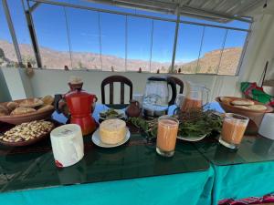 a table with food and drinks on top of it at hotel orkkowasi colca in Coporaque +17 photos