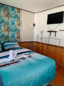 a room with a bed with a painting on the wall at Koh Samed Lungdam Hutbeach เกาะเสม็ดลุงดำฮัทบีช in Ao Phutsa