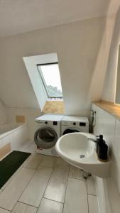 a bathroom with a sink and a washing machine at Construction worker's apartment in Hof in Hof +61 photos