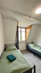 a bedroom with two beds and a window at Construction worker's apartment in Hof in Hof