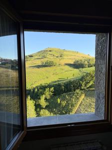 a view of a hill from a window at Izarra Urdaneta in Aizarna