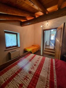 a bedroom with a bed and a window and a staircase at Chalet Silence - Grand Haury in Auri Grande