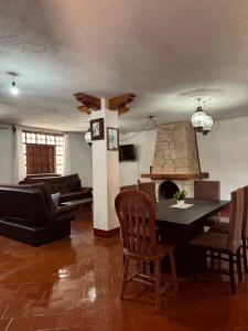 a living room with a table and a fireplace at LA CASA DE DOÑA EMMA in Mazamitla +24 photos