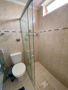 a bathroom with a toilet and a glass shower at Antigo hotel murubira in Belém +4 photos