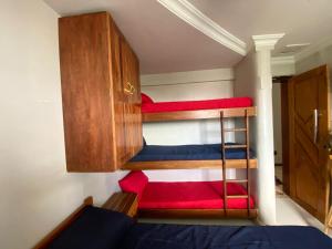 a room with two bunk beds and a cabinet at Antigo hotel murubira in Belém