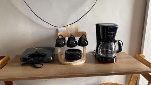 a wooden shelf with a coffee maker and a coffee pot at Antigo hotel murubira in Belém