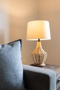 a lamp sitting on a table next to a couch at The Beach Point - Ground Floor BBQ in Invermere