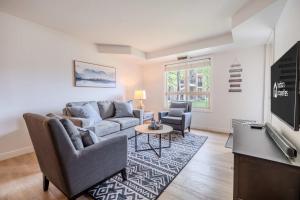 a living room with a couch and a tv at The Beach Point - Ground Floor BBQ in Invermere +20 photos