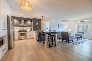 a kitchen and living room with a table and chairs at The Beach Point - Ground Floor BBQ in Invermere