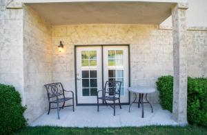 a patio with chairs and a table in front of a door at Villa 1041 - 3 Bed 3 Bath Full Kitchen villa in Midway