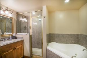 a bathroom with a tub and a shower and a sink at Villa 1041 - 3 Bed 3 Bath Full Kitchen villa in Midway +46 photos