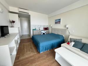 a small bedroom with a bed and a couch at Studio Cris Sea View in Blaxy Residence in Douăzeci şi Trei August