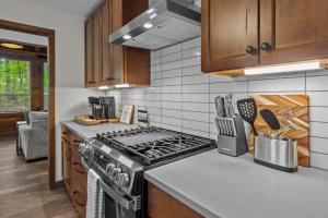 a kitchen with a stove and a counter top at Jackson’s Urban Cabin Escape in Jackson