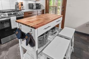 a kitchen with a wooden counter top and a stove at Jackson’s Urban Cabin Escape in Jackson +53 photos