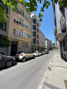 a street with cars parked on the side of a building at Kardes Apartment in Istanbul