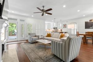a living room with two chairs and a ceiling fan at 1005 Crooked Oak Lane in Seabrook Island +43 photos