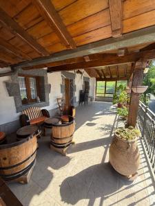 a patio with tables and chairs under a wooden pergola at Izarra Urdaneta in Aizarna